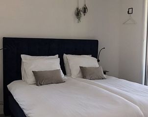 Comfortable bedroom in Holiday home in Zeewolde with double bed.