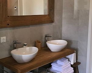 Modern bathroom with double sink in cottage in Zeewolde.
