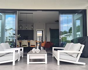 Spacious porch of Holiday home in Zeewolde with comfortable chairs.