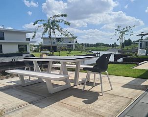Outdoor dining area with beautiful view at Holiday Home in Zeewolde, Flevoland.