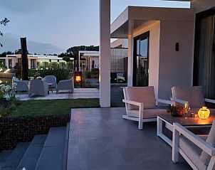 Atmospheric evening terrace at cottage in Zeewolde with candlelight.