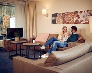 Koppel geniet van een ontspannen moment in WestCord ApartHotel Boschrijck, West-Terschelling.