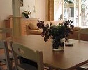 Cozy interior of De Vlier vacation home in Appelscha, Friesland with dining area and bright living room.