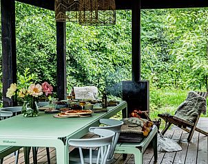 Gemtliche Veranda des Ferienhauses in Appelscha, Ferienhaus in den friesischen Wldern, Friesland, mit Blick ins Grne und gemtlichem Essbereich.