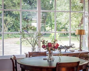 Gezellige eetkamer in vakantiehuis Oldeberkoop, Friesland, met houten meubels.