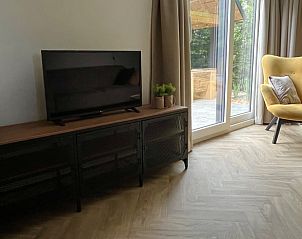 Moderne TV-Ecke im Ferienhaus in Oosterwolde mit Blick auf die Terrasse, Friesland.