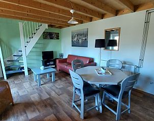 Ruime woonkamer in Vakantiehuis in Boijl, Friesland met houten plafond.