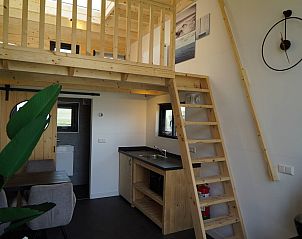 Interieur van Chalet in Hindeloopen, met houten loft en compacte keuken, ideaal voor een vakantie in Friesland.