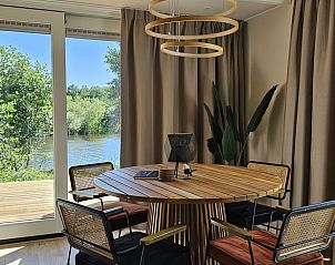 Stijlvolle eetkamer in Huisje in Westergeest met uitzicht op de rivier.