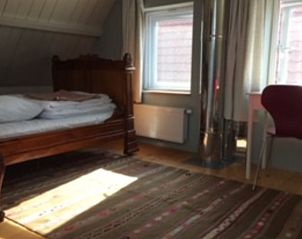 Ruime slaapkamer in het vakantiehuis in Scherpenzeel met veel natuurlijk licht.