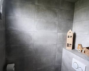 Stijlvolle badkamer met grijze tegels in Vakantiehuisje in Poppenwier.