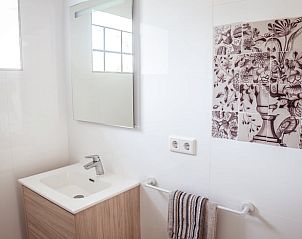 Uitgestrekte tuin in Vakantiehuis in Drogeham, Friesland, met zorgvuldig gesnoeide heggen.