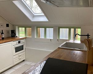 Lichte keuken in Vakantiehuisje in Longa met houten werkblad en veel lichtinval.