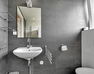 Wastafel en spiegel in Huske 2 vakantiehuis, Tzummarum, Friesland.