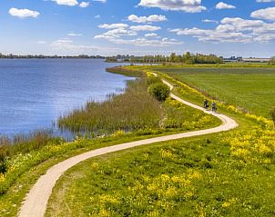 Fietspad langs het water in Friesland, perfect voor een dagtocht vanuit Vakantiehuisje in Weidum.