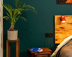 Sfeervolle slaapkamer met decoratie in Huisje in Stiens, gelegen op het Friese platteland, Friesland.