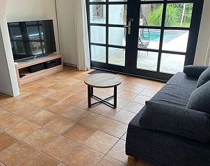 Stijlvolle woonkamer in Vakantiehuis in Beuningen, Gelderland met uitzicht op het zwembad.