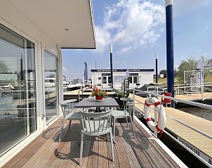 Ruim terras van Mi La Luna vakantiehuis in Kerkdriel, Gelderland met uitzicht op de haven.