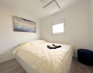 Comfortabele slaapkamer in Mi La Luna vakantiehuis in Kerkdriel, Gelderland met kunst aan de muur.