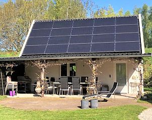 Zonnig terras bij Vakantiehuisje in Hurwenen, Rivierengebied, Gelderland met groene omgeving.