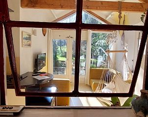 Uitzicht vanuit raam van Vakantiehuis in Beek-Ubbergen op groene tuin.