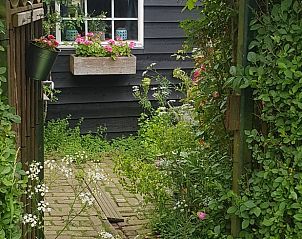 Knusse zithoek met haard bij Huisje in Zoelen, vakantiehuis in Rivierengebied, Gelderland.