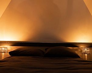 Sfeervolle slaapkamer met lampen in Vakantiehuisje in Winssen, Rivierengebied.