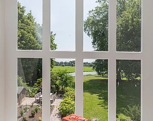 Panoramisch uitzicht vanuit Huisje in Kerk-Avezaath, Gelderland, op groene velden.