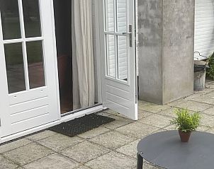 Veranda of holiday home in Opheusden, located in the River Region of Gelderland, with open doors to the garden.