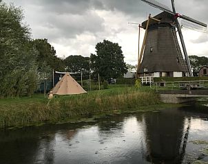 Gezellige glamping bij Huisje in Geldermalsen, gelegen naast een historische molen in het groene Rivierengebied, Gelderland.