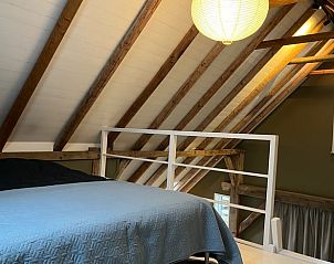 Cozy bedroom in Holiday Home in Winterswijk with wooden details and a soothing ambiance.