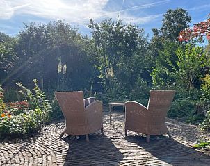 Charming wooden vacation home in Winterswijk surrounded by lush gardens in Achterhoek, Gelderland.