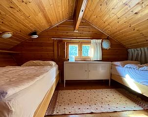 Attic room in vacation home in Winterswijk, with wooden interior and comfortable bed in Achterhoek, Gelderland.