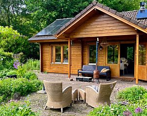 Veranda of vacation home in Winterswijk, with seating and garden views in Achterhoek, Gelderland.