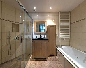 Modern bathroom in Holiday Home in Winterswijk, Achterhoek with shower and bathtub.