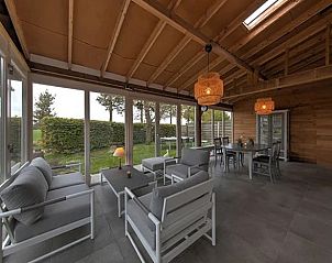 Spacious indoor space with sitting area in Holiday Home in Winterswijk for relaxation and coziness.