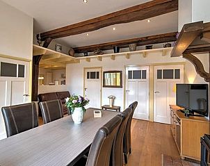 Attractive dining room in Holiday home in Winterswijk, Achterhoek with wooden beams and decor.