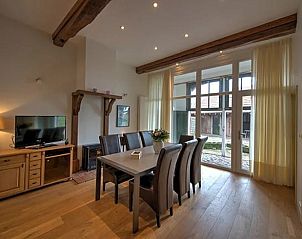 Bright living room in Holiday home in Winterswijk with large windows and wooden floor.