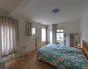Cozy bedroom in Holiday Home in Winterswijk with large windows and natural light.
