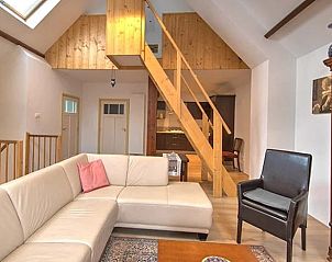 Stylish living room in Holiday Home in Winterswijk with open staircase and comfortable seating area.