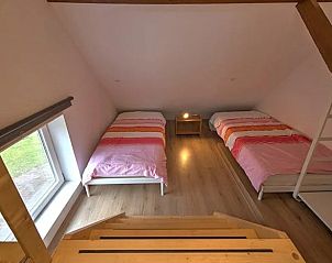 Attic room in Holiday Home in Winterswijk with two beds and cozy furnishings.