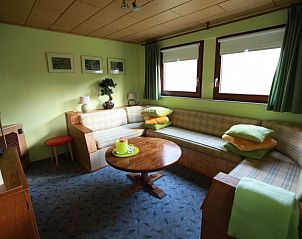 Spacious sitting area in Cottage, Winterswijk, Achterhoek, with lots of natural light and comfortable furniture.