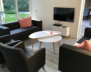 Cozy living room in Holiday Home in Winterswijk, Achterhoek, with modern furniture and garden views.