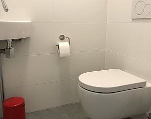 Stylish bathroom in Holiday Home in Winterswijk, Achterhoek, with clean white tiles and modern furnishings.