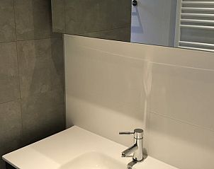 Elegant sink cabinet in Holiday home in Winterswijk, Achterhoek, with modern finish and spacious mirror.