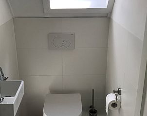 Compact toilet on the upper floor of Holiday Home in Winterswijk, Achterhoek, with clean white finish.