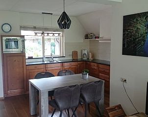 Eetruimte en keuken in Huisje in Barchem, vakantiehuis in de Achterhoek, met houten meubels en moderne voorzieningen.