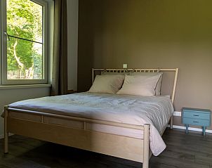 Slaapkamer in Vakantiehuis in Rekken met comfortabel bed en uitzicht op de Achterhoek, Gelderland.