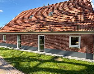 Zijaanzicht van het vakantiehuis Huisje in Aalten, Achterhoek, met traditionele rode dakpannen.
