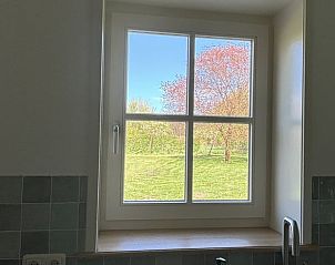 Uitzicht op de tuin vanuit de keuken van Huisje in Aalten, vakantiehuis in Aalten, Achterhoek, met veel natuurlijk licht.